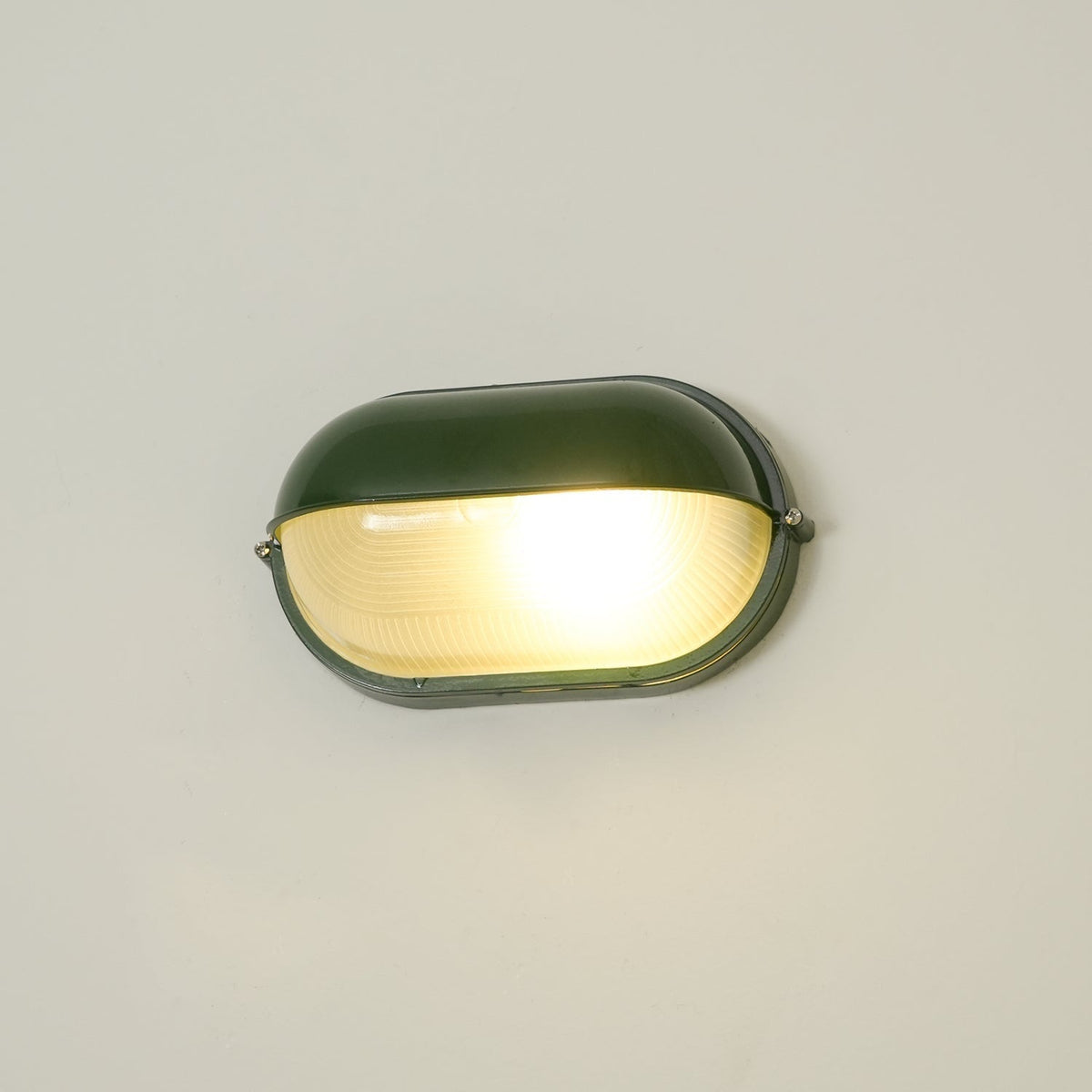 Outdoor Bulkhead Wall Light with Oval Shield and Ribbed Glass Diffuser
