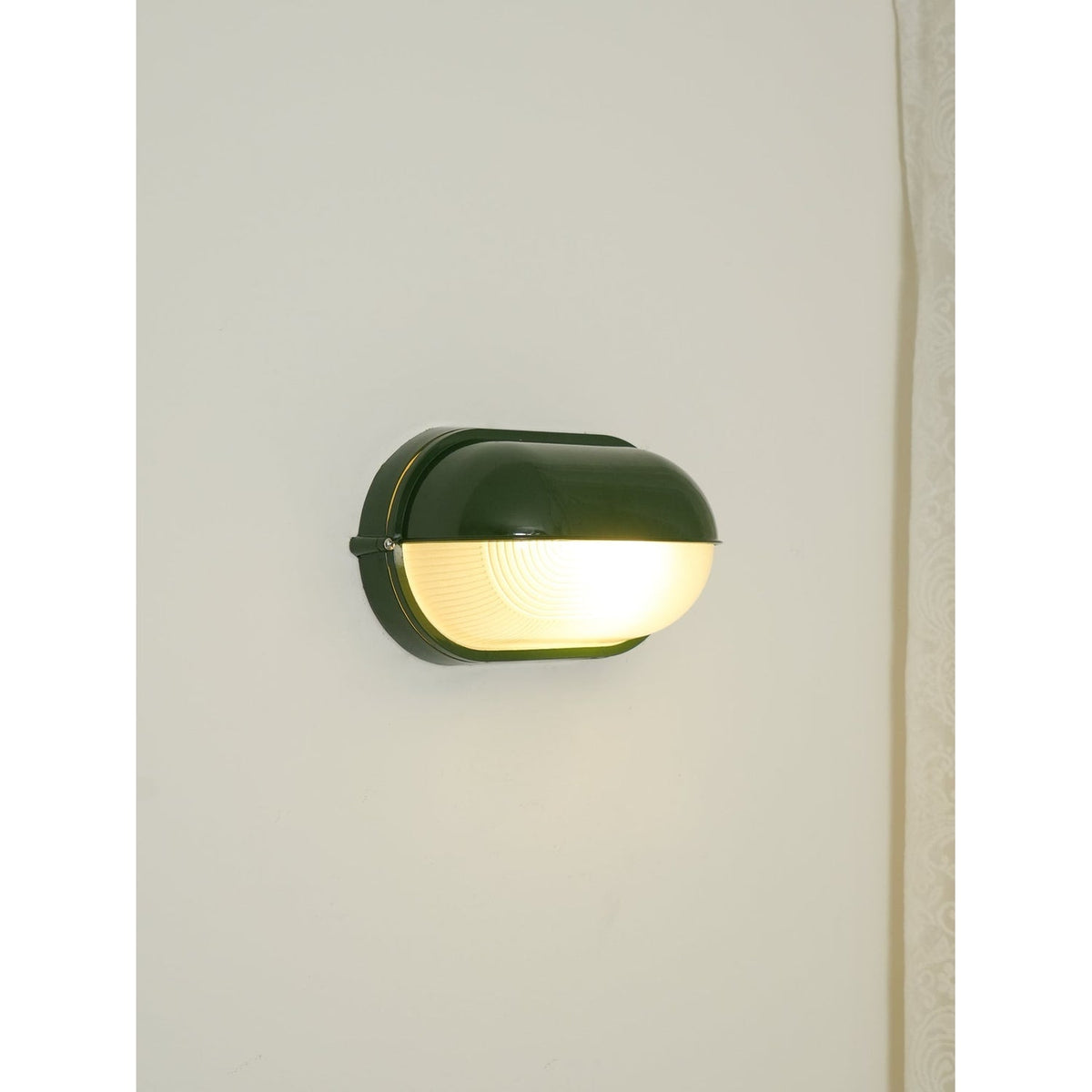 Outdoor Bulkhead Wall Light with Oval Shield and Ribbed Glass Diffuser