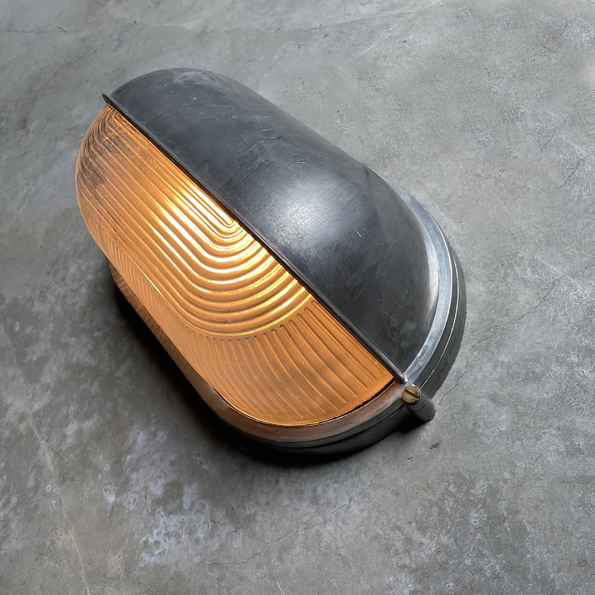 Outdoor Bulkhead Wall Light with Oval Shield and Ribbed Glass Diffuser