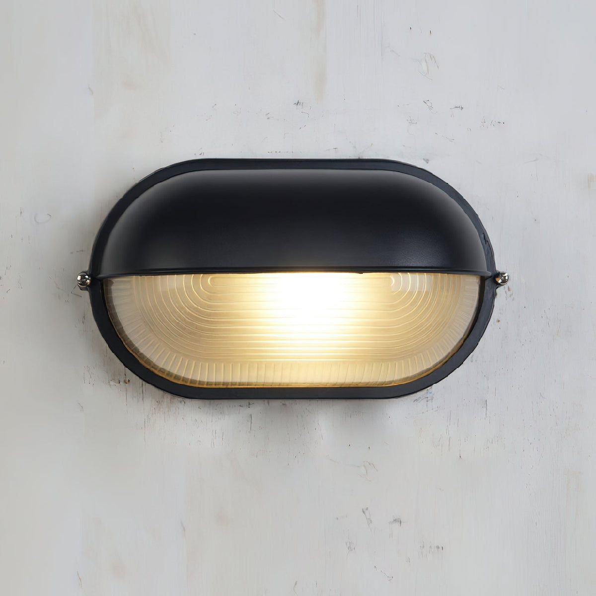 Outdoor Bulkhead Wall Light with Oval Shield and Ribbed Glass Diffuser