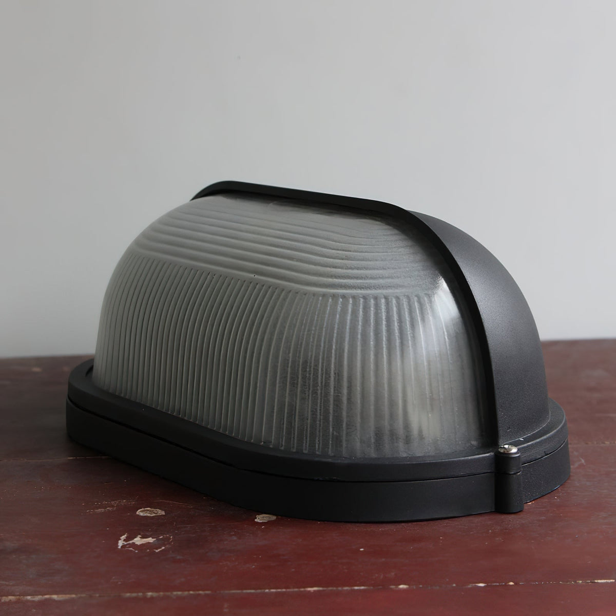 Outdoor Bulkhead Wall Light with Oval Shield and Ribbed Glass Diffuser