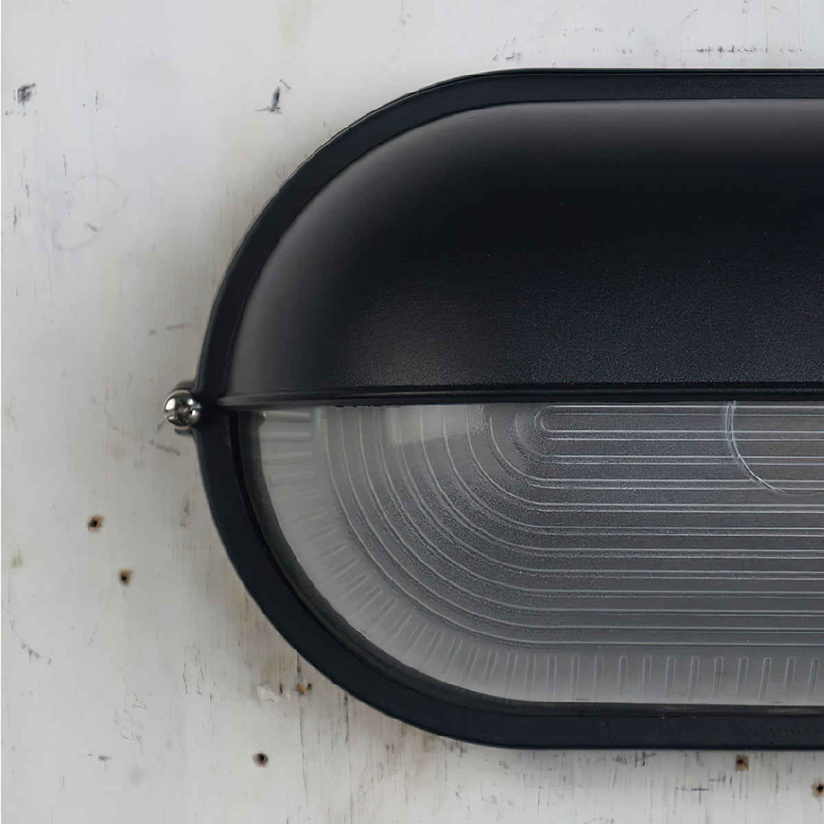 Outdoor Bulkhead Wall Light with Oval Shield and Ribbed Glass Diffuser