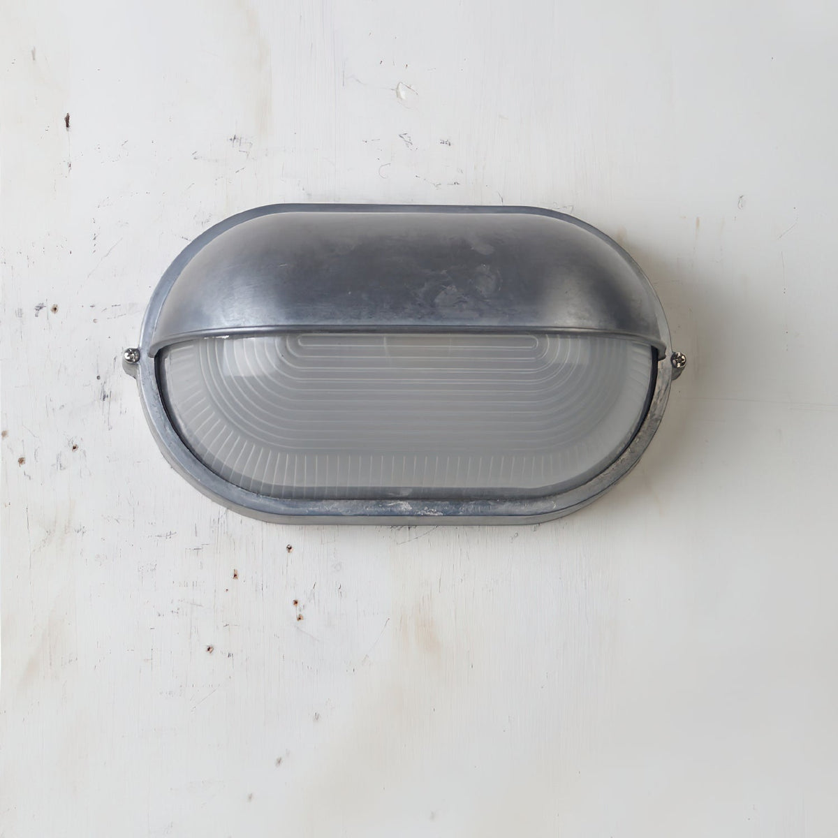 Outdoor Bulkhead Wall Light with Oval Shield and Ribbed Glass Diffuser