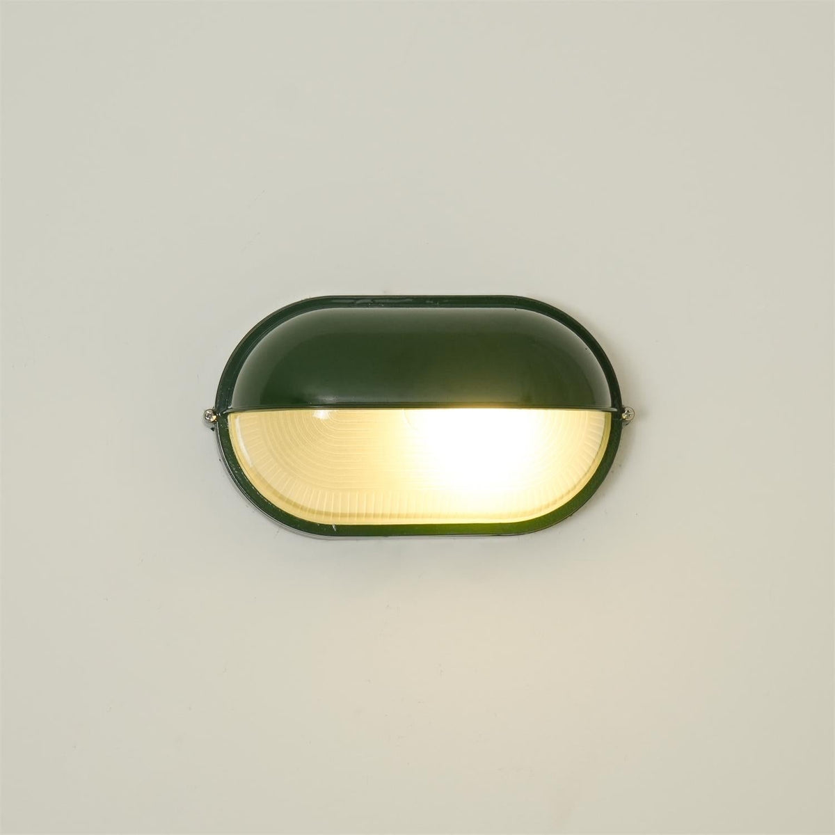Outdoor Bulkhead Wall Light with Oval Shield and Ribbed Glass Diffuser