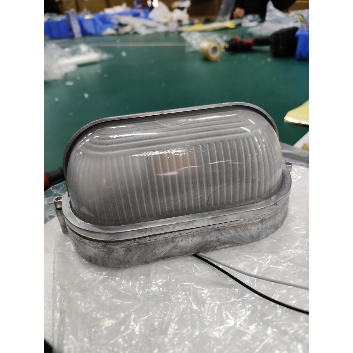 Outdoor Bulkhead Wall Light with Oval Shield and Ribbed Glass Diffuser