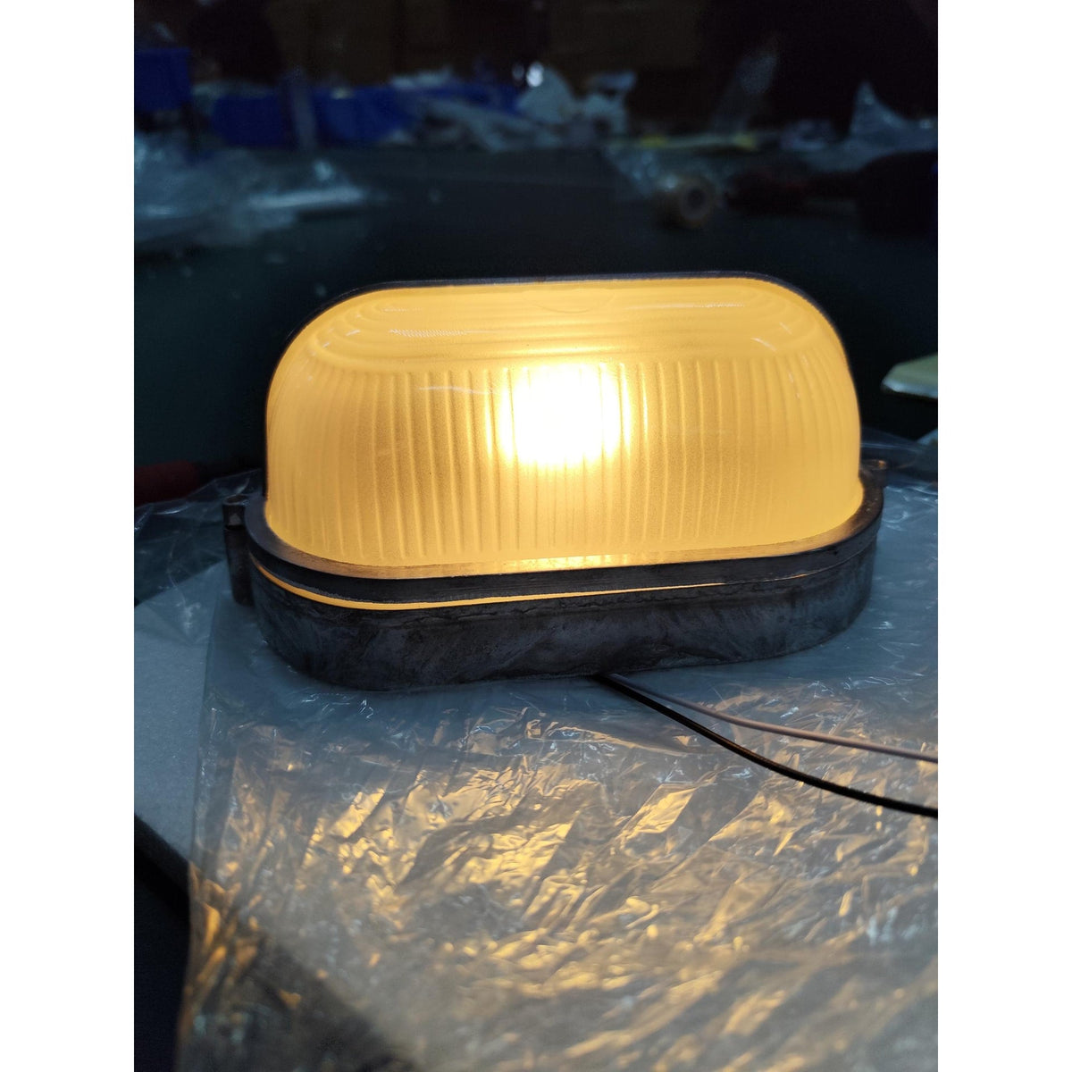 Outdoor Bulkhead Wall Light with Oval Shield and Ribbed Glass Diffuser