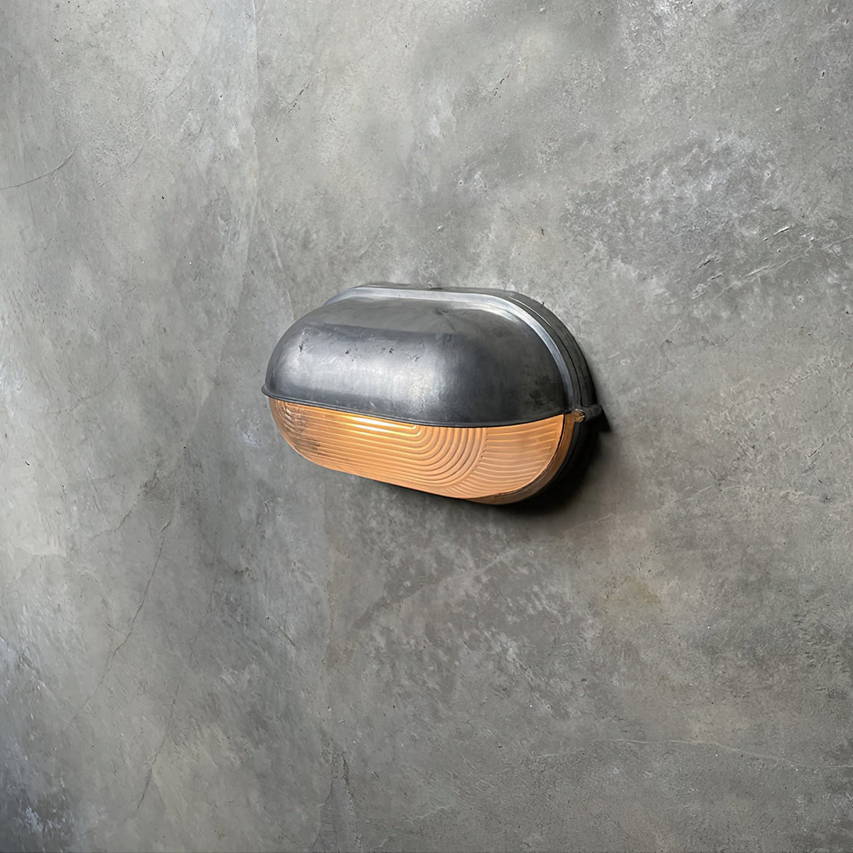 Outdoor Bulkhead Wall Light with Oval Shield and Ribbed Glass Diffuser