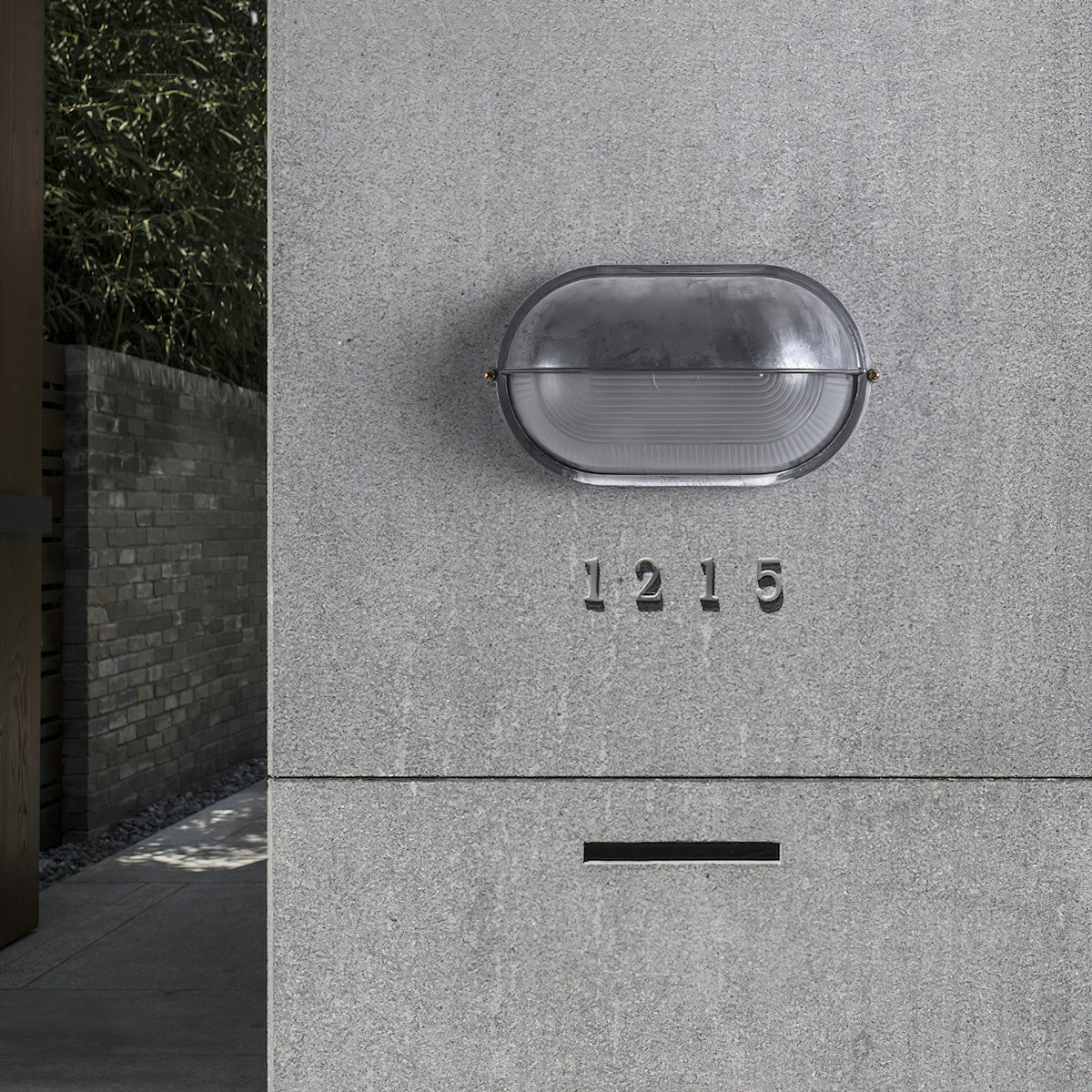 Outdoor Bulkhead Wall Light with Oval Shield and Ribbed Glass Diffuser