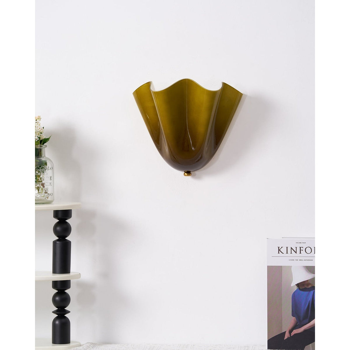 Wall Sconce with Wavy Glass Shade and Warm Ambient Lighting