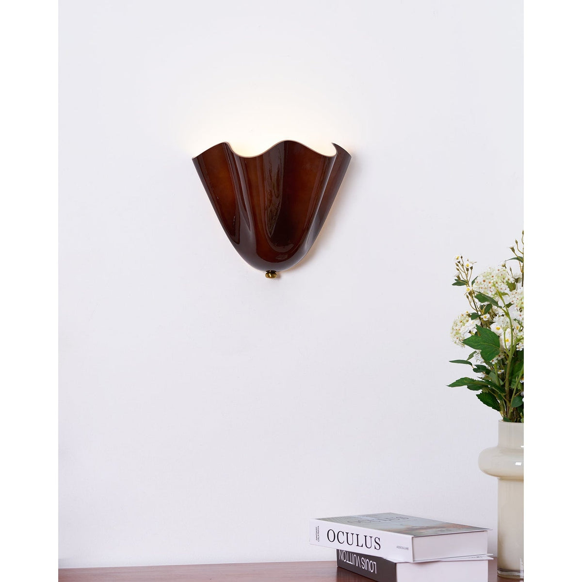 Wall Sconce with Wavy Glass Shade and Warm Ambient Lighting