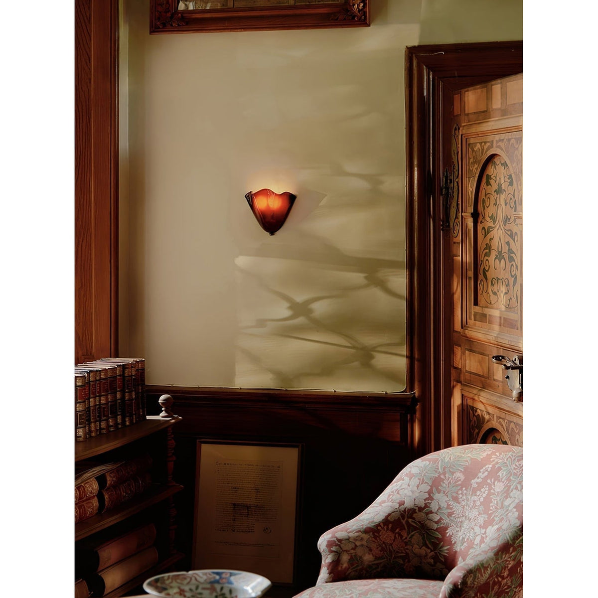 Wall Sconce with Wavy Glass Shade and Warm Ambient Lighting