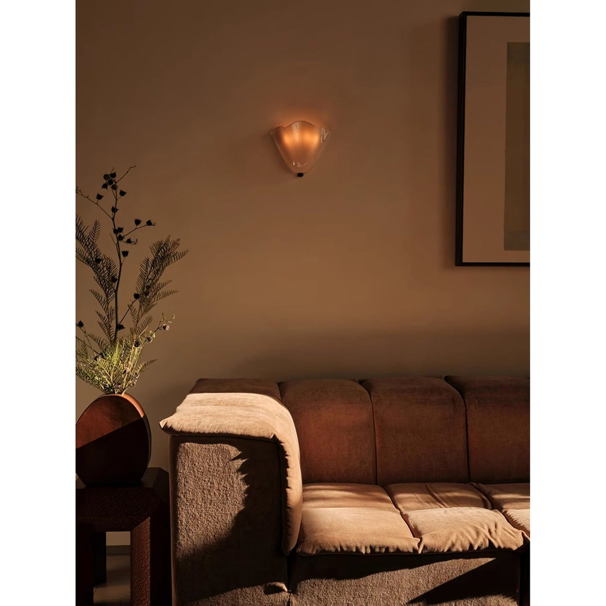 Wall Sconce with Wavy Glass Shade and Warm Ambient Lighting