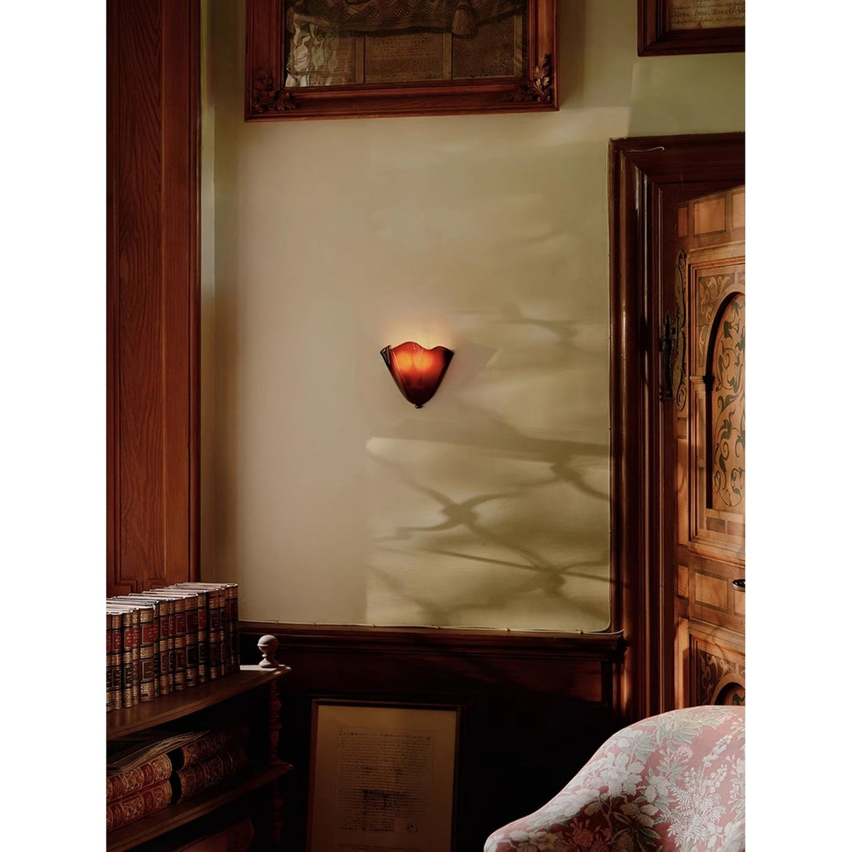 Wall Sconce with Wavy Glass Shade and Warm Ambient Lighting