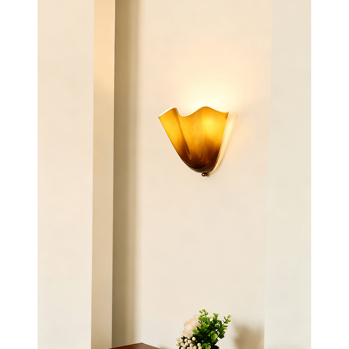 Wall Sconce with Wavy Glass Shade and Warm Ambient Lighting