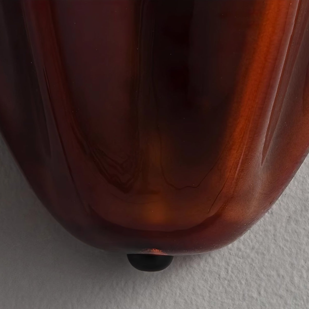 Wall Sconce with Wavy Glass Shade and Warm Ambient Lighting