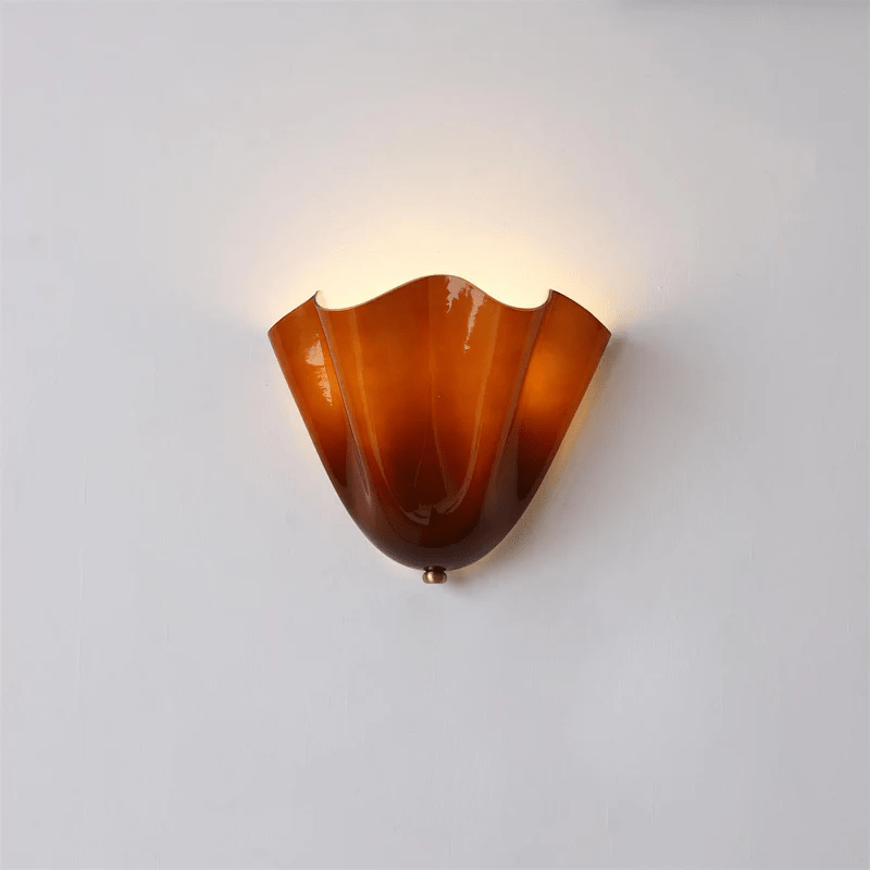 Wall Sconce with Wavy Glass Shade and Warm Ambient Lighting
