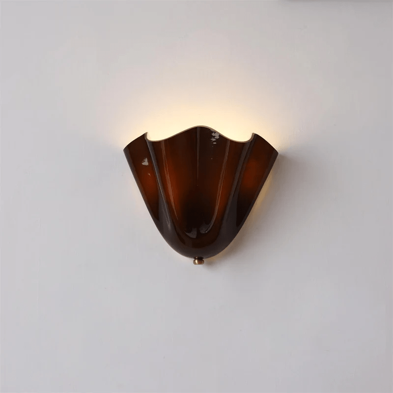 Wall Sconce with Wavy Glass Shade and Warm Ambient Lighting