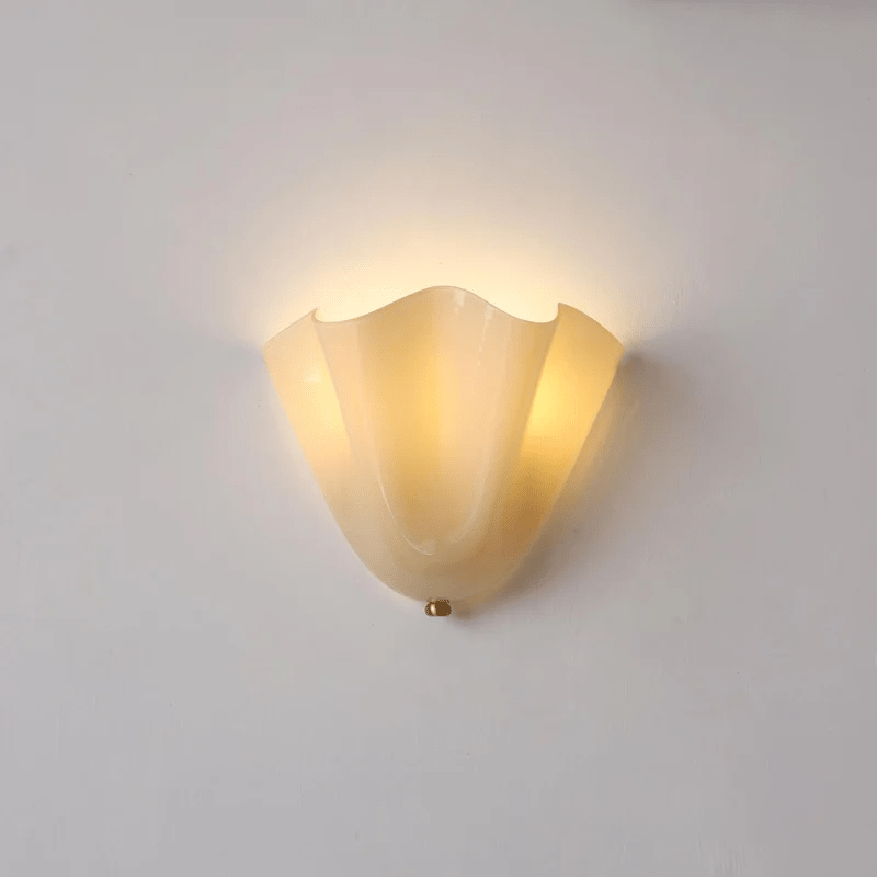 Wall Sconce with Wavy Glass Shade and Warm Ambient Lighting