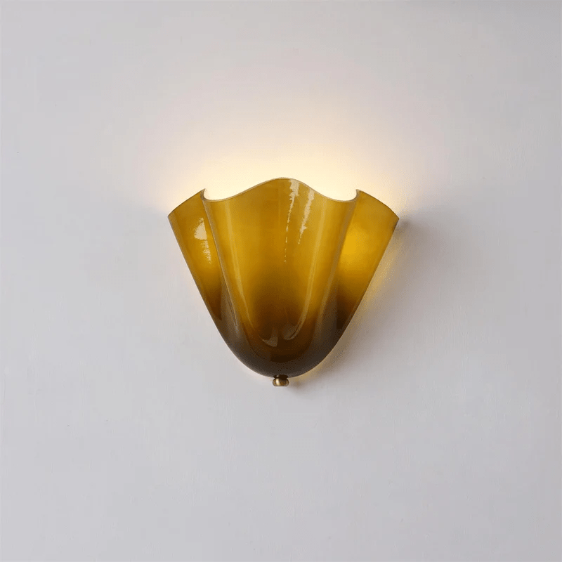 Wall Sconce with Wavy Glass Shade and Warm Ambient Lighting