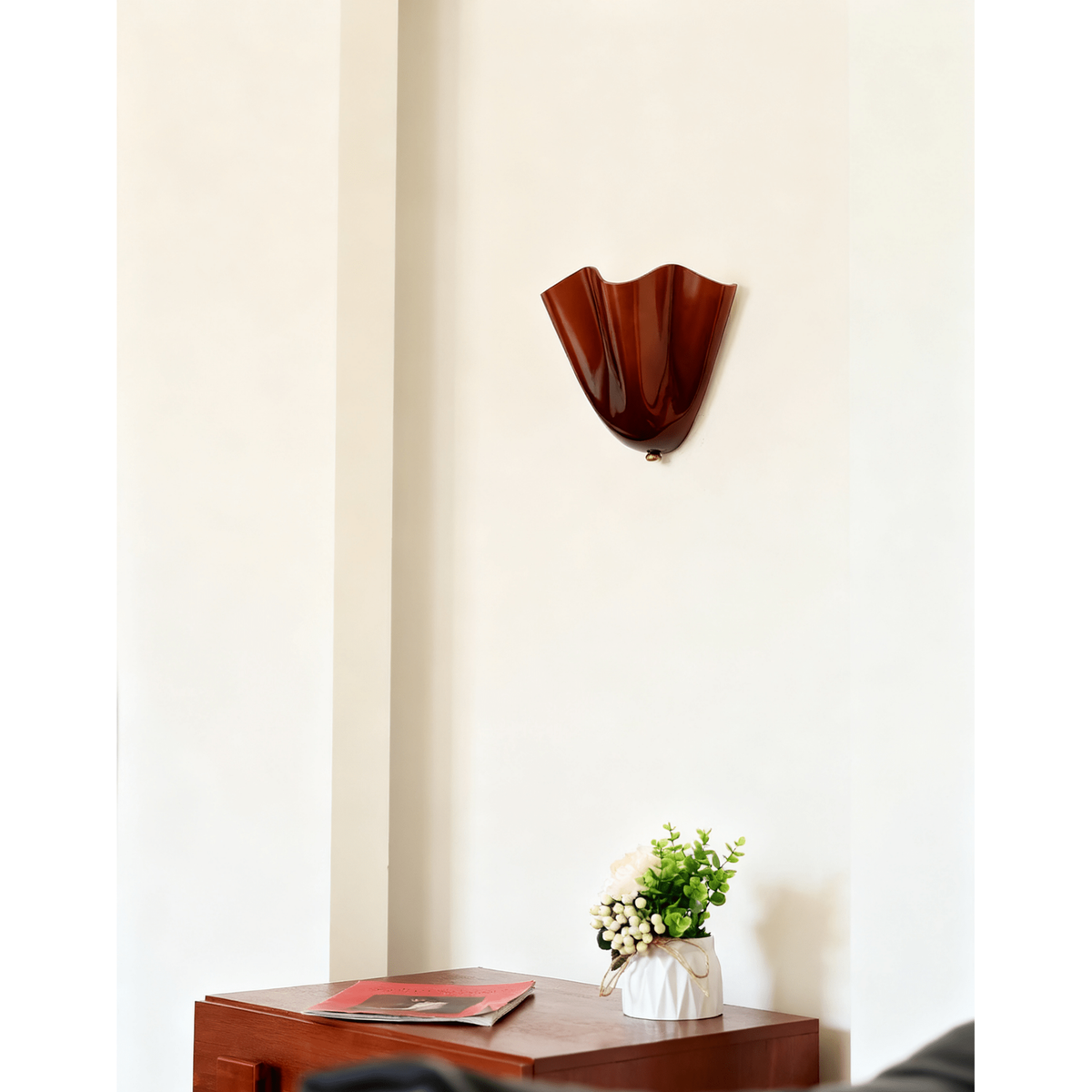 Wall Sconce with Wavy Glass Shade and Warm Ambient Lighting