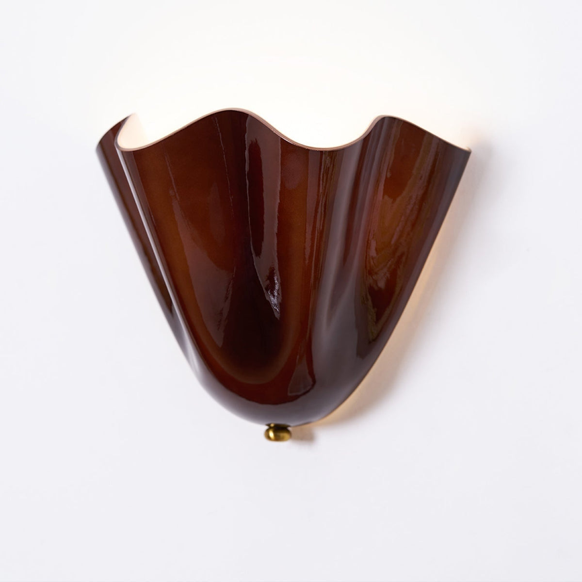 Wall Sconce with Wavy Glass Shade and Warm Ambient Lighting