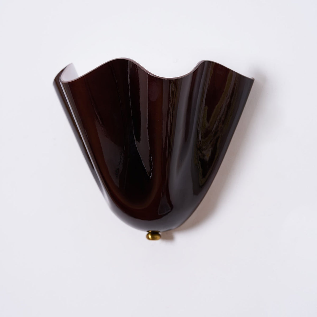 Wall Sconce with Wavy Glass Shade and Warm Ambient Lighting