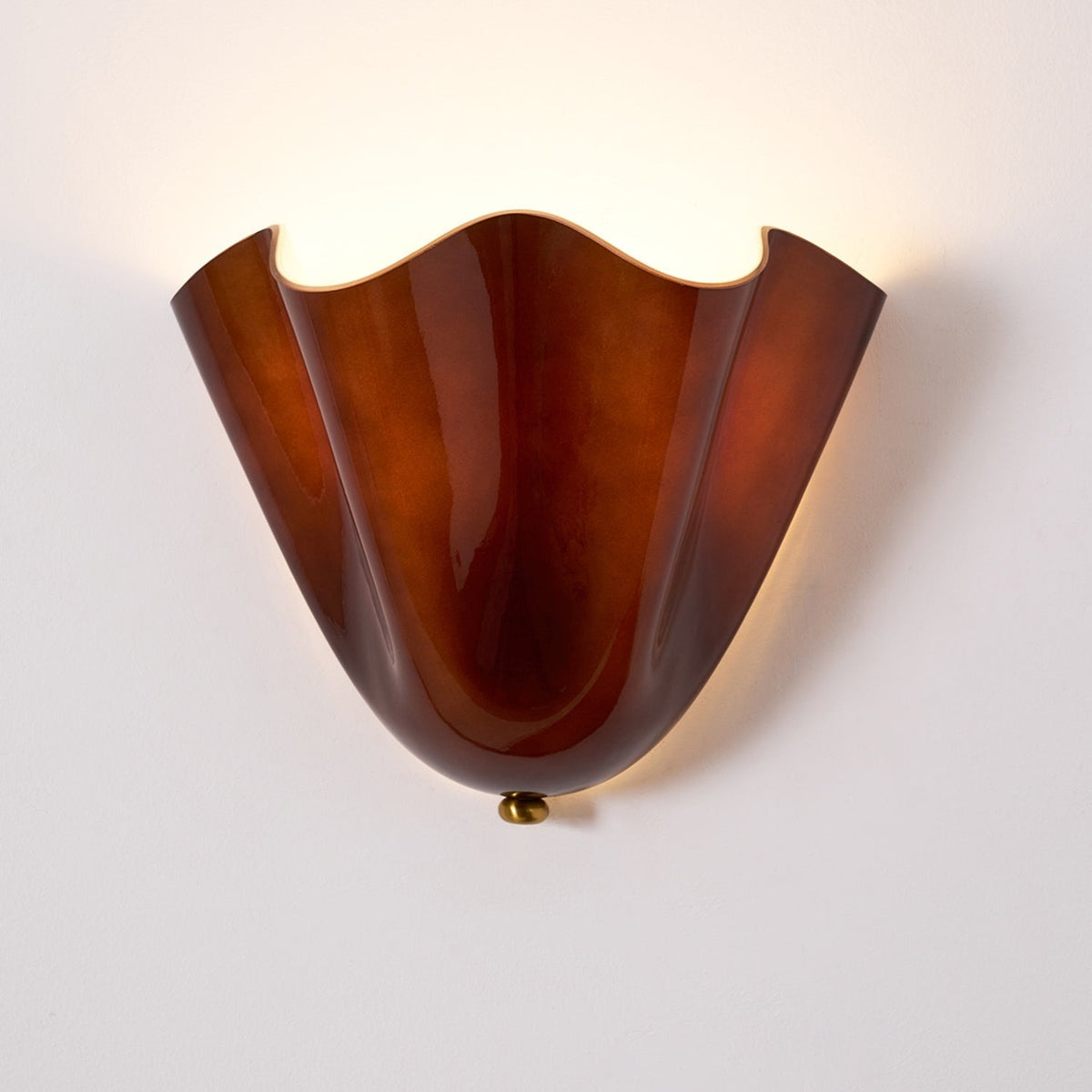 Wall Sconce with Wavy Glass Shade and Warm Ambient Lighting