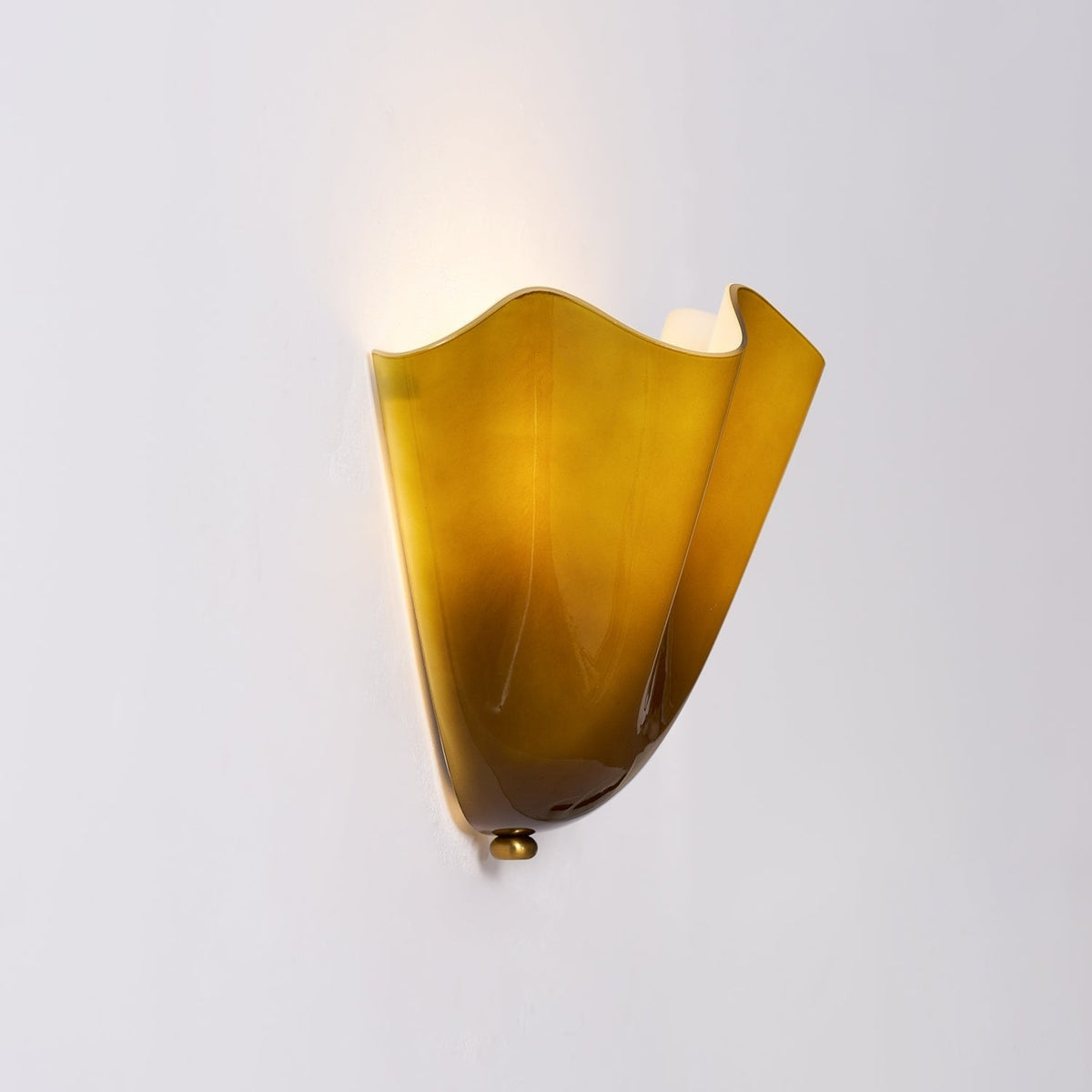 Wall Sconce with Wavy Glass Shade and Warm Ambient Lighting