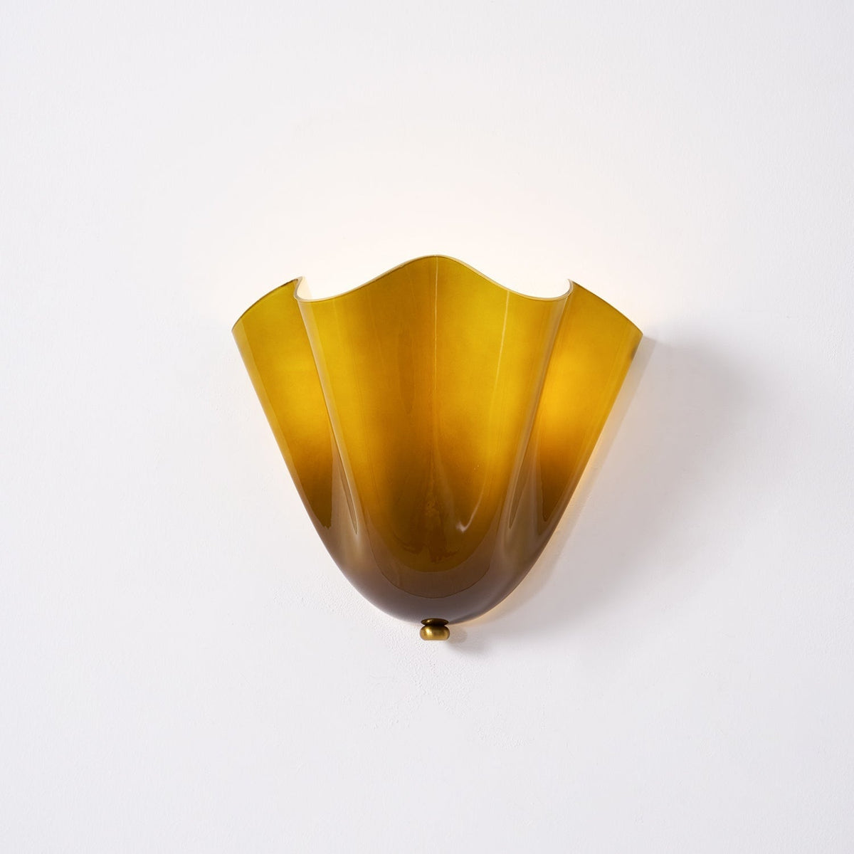 Wall Sconce with Wavy Glass Shade and Warm Ambient Lighting