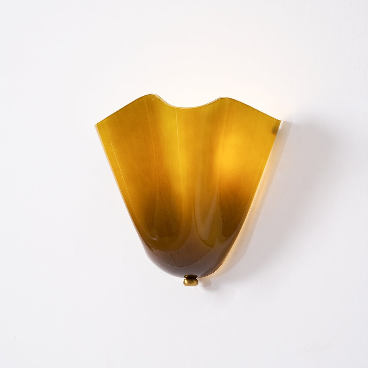 Wall Sconce with Wavy Glass Shade and Warm Ambient Lighting