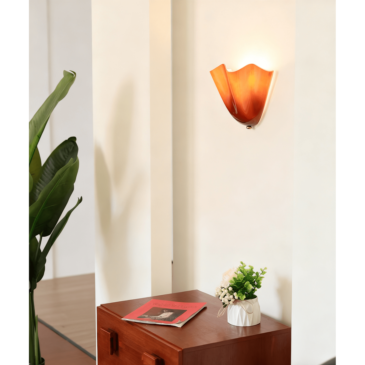 Wall Sconce with Wavy Glass Shade and Warm Ambient Lighting
