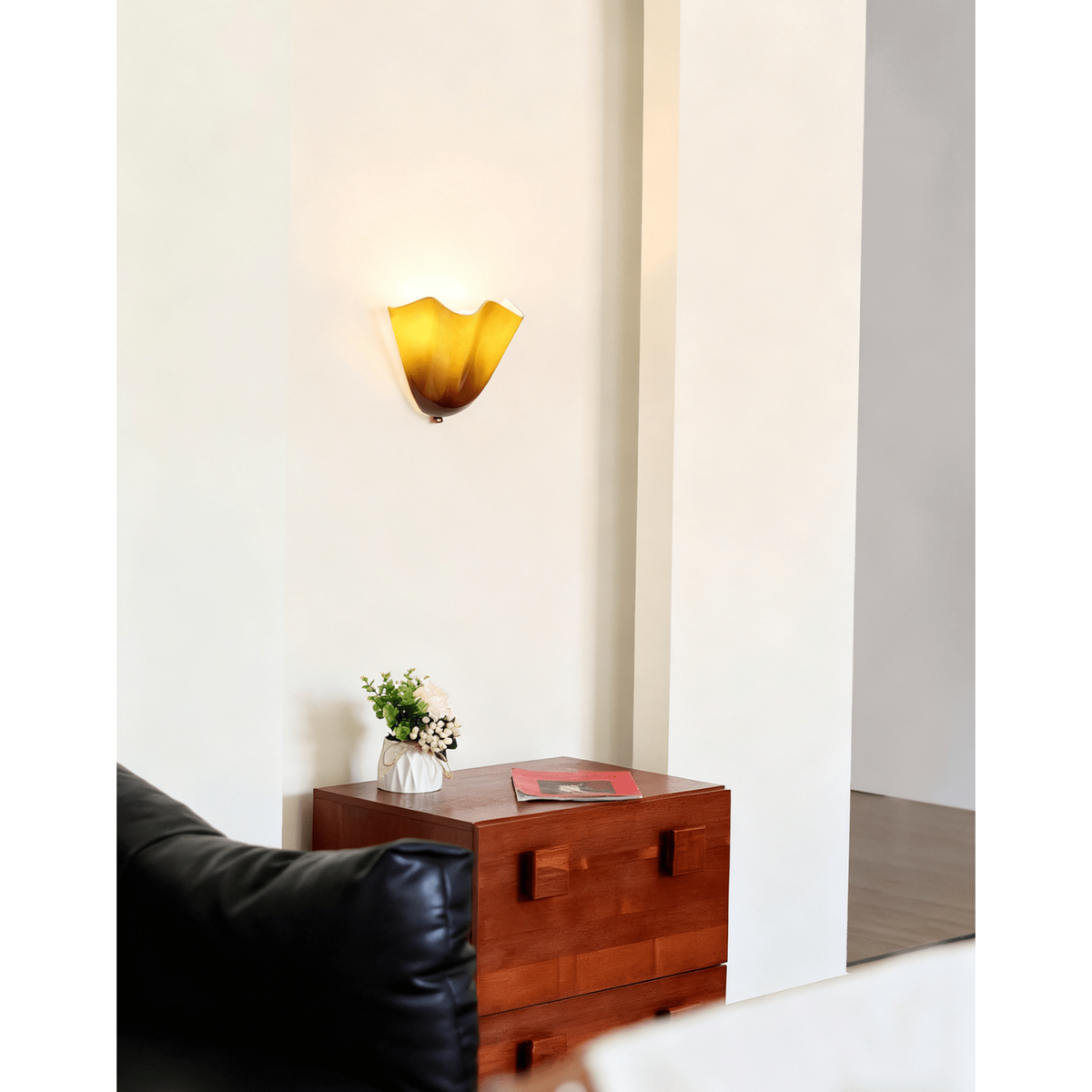Wall Sconce with Wavy Glass Shade and Warm Ambient Lighting