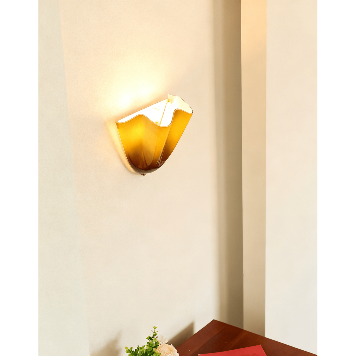 Wall Sconce with Wavy Glass Shade and Warm Ambient Lighting