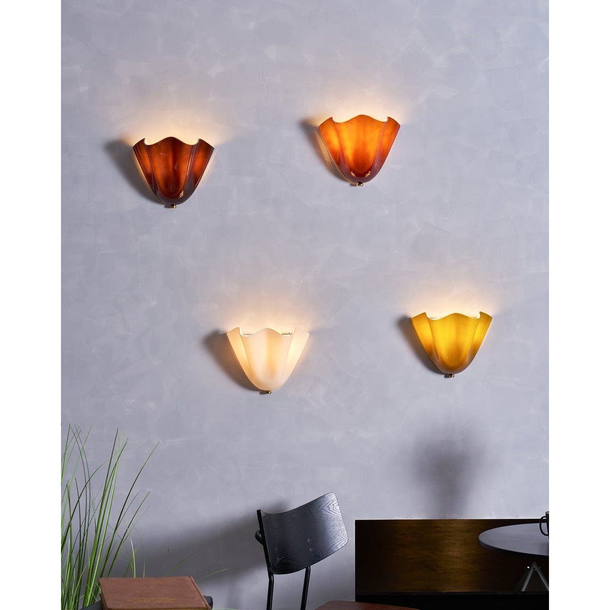 Wall Sconce with Wavy Glass Shade and Warm Ambient Lighting