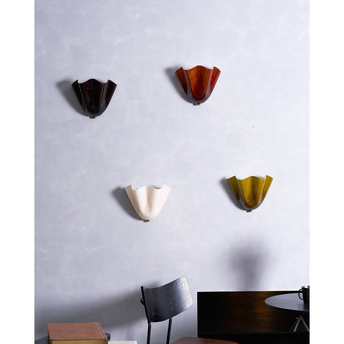 Wall Sconce with Wavy Glass Shade and Warm Ambient Lighting