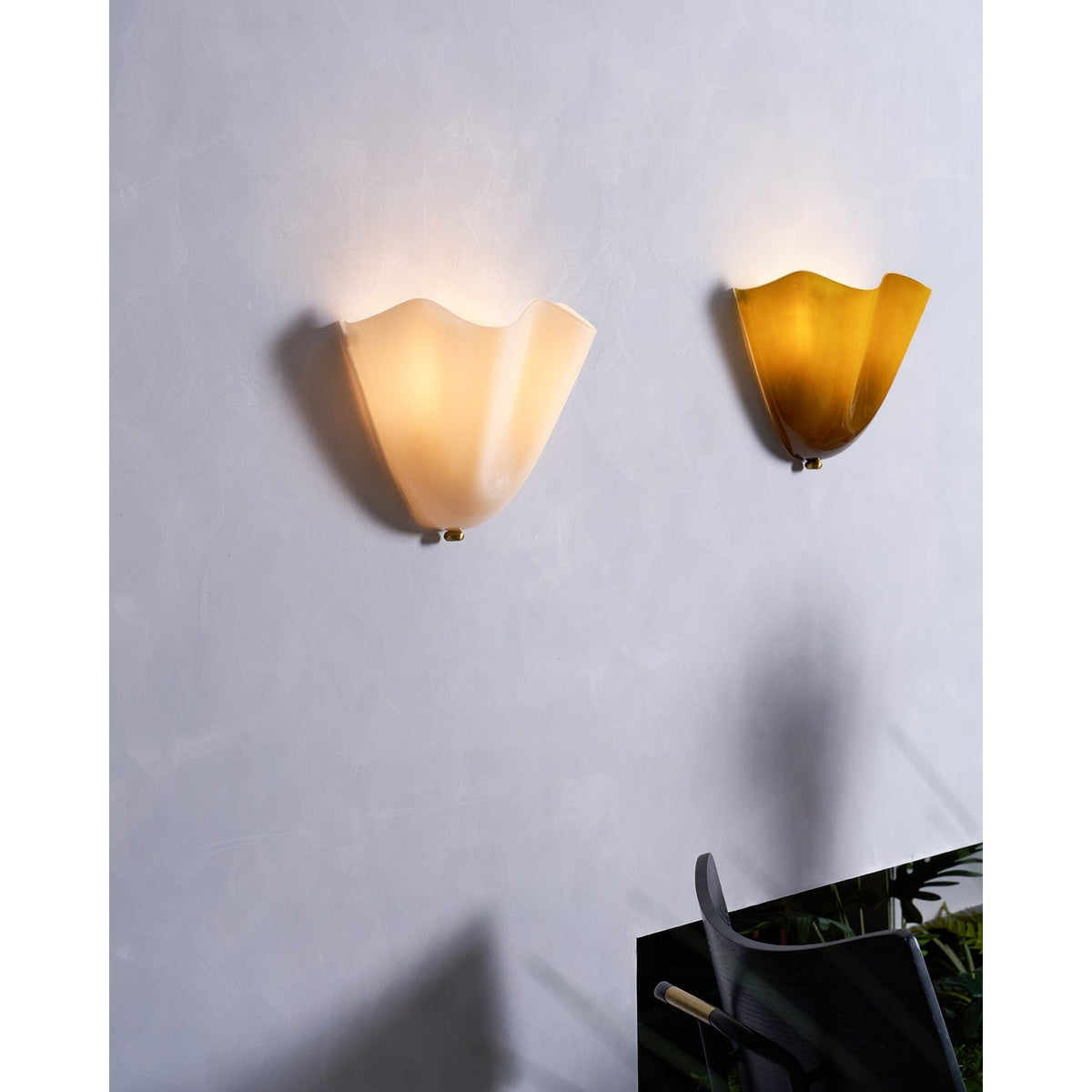 Wall Sconce with Wavy Glass Shade and Warm Ambient Lighting