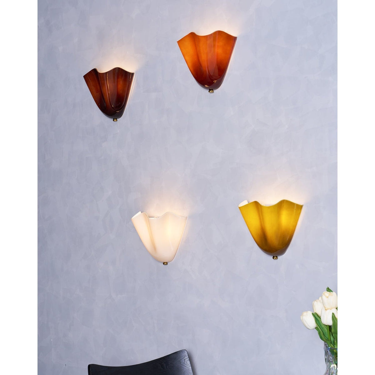 Wall Sconce with Wavy Glass Shade and Warm Ambient Lighting