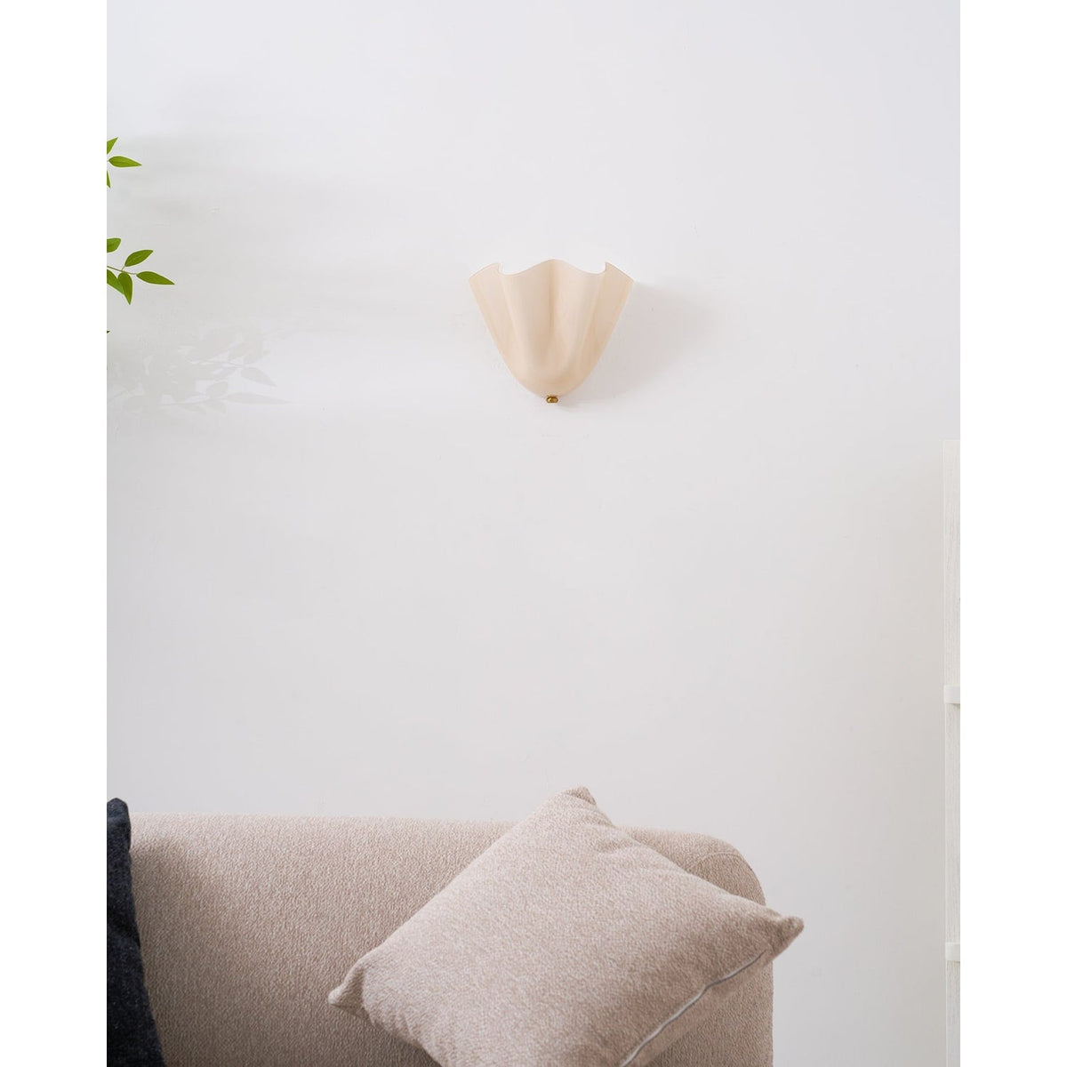 Wall Sconce with Wavy Glass Shade and Warm Ambient Lighting