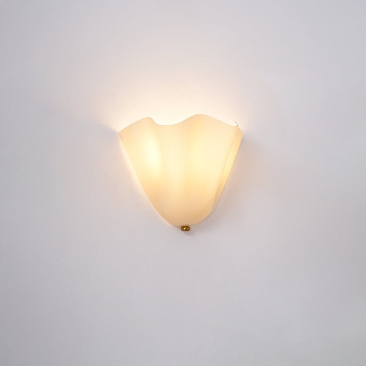 Wall Sconce with Wavy Glass Shade and Warm Ambient Lighting