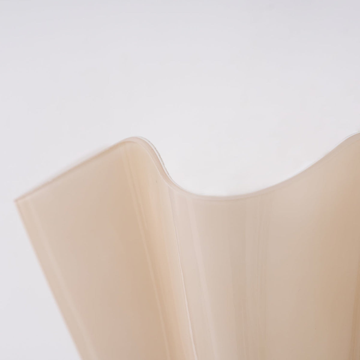Wall Sconce with Wavy Glass Shade and Warm Ambient Lighting
