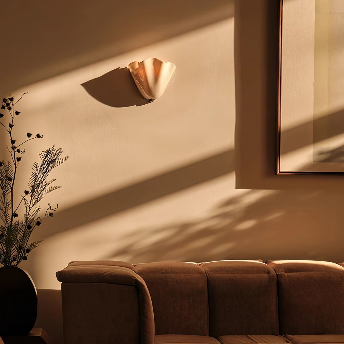 Wall Sconce with Wavy Glass Shade and Warm Ambient Lighting