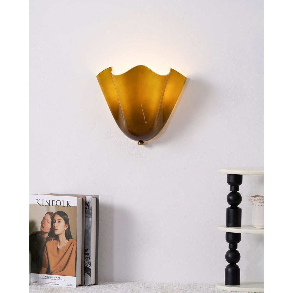 Wall Sconce with Wavy Glass Shade and Warm Ambient Lighting
